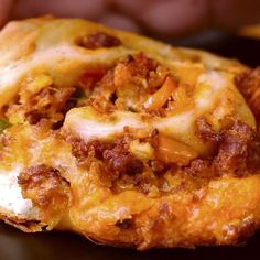 a cheesy bread with meat and cheese on it