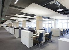 an empty office with desks and chairs