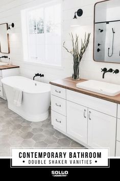 a bathroom with two sinks and a bathtub in the middle, surrounded by white cabinets