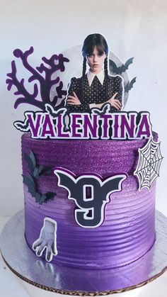 a cake decorated with purple frosting and spooky decorations is displayed in front of a white background