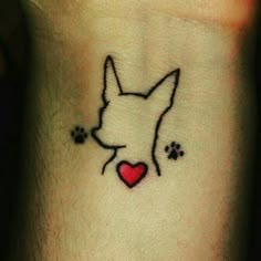 a small tattoo with a dog's face and paw prints