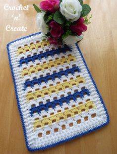 a crocheted table mat with flowers on it