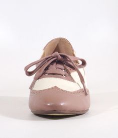 These delightful 1950s saddle shoes from Chelsea Crew blend classic elegance with a playful spirit, featuring a stylish mauve and bone color scheme that’s perfect for any outfit. The chic perforation detail adds a touch of whimsy, while the lace-up vamp ensures you’ll stay comfy all day long. Complete with a 1 inch heel.This is a Special Order item, please allow a 2-3 day handling time.Sizing runs small, if you're in between sizes, size up.Available while supplies last. Saddle Shoes, Bone Color, Classic Elegance, The Chic, Color Scheme, Unique Vintage, Saddle, 1 Inch, Bones