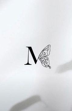 the letter m with a butterfly on it's back side is shown in black and white