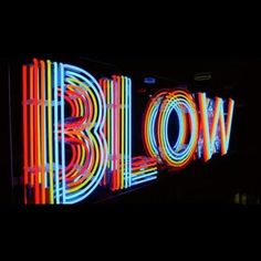 the word blow painted with neon lights in front of a black background that says blow