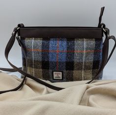 Our Harris Tweed Large Shoulder Bag is a brilliant size with a durable style, that can be used every day. The shoulder bag has one main compartment, secured with a zip. Inside this Harris Tweed bag there are open pockets for phones and essentials as well as a small zip compartment. This bag has a short shoulder strap as well as a longer detachable strap that you can wear across your body. Large Shoulder Bag Dimensions: 20cm x 30cm x 9cm The vegan leather trim colour will differ depending on the Brown Tweed Shoulder Bag For Everyday Use, Rectangular Tweed Shoulder Bag For Travel, Rectangular Tweed Shoulder Bag For Everyday Use, Rectangular Tweed Shoulder Bag For Everyday, Brown Tweed Shoulder Bag For Travel, Everyday Tweed Crossbody Bag, Everyday Tweed Satchel Shoulder Bag, Harris Tweed Bag, Colours Of Nature