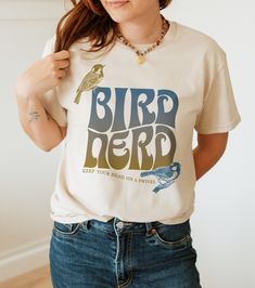 Thanks for checking out this BOHO style shirt for Bird lovers. Do you love watching birds and came name many of your feathered friends? Then this Bird Nerd Tshirt might be for you! This design uses trendy retro fonts, wave layout, and earthy fading colors for those fun hippie vibes. This tee is made with love by a fellow Bird Lover. This T-shirt, the Gildan 6400 Soft Style short sleeve tee, is a great fit with a soft feel to the fabric. But also has the same high quality of the well loved standa Casual Crew Neck T-shirt With Bird Print, Nerd Tshirt, Nerd Tshirts, Nerd Shirt, Boho Birds, Nerd Shirts, Bird Shirt, Hippie Vibes, Bird Watcher