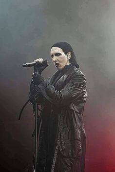 a man in black jacket holding a microphone