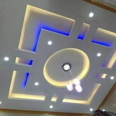 the ceiling is decorated with blue lights and white trimmings, along with recessed lighting