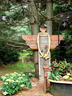 a wooden sculpture sitting in the middle of a forest