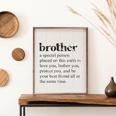 a wooden shelf with three plates on it and a framed print that says,'brother a special person placed on this earth to love you, another you, and be your best friend all at the same time