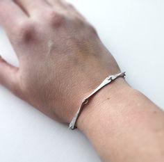 "Handmade sterling silver bracelet. An elegant simple design of several perfect gemetric shapes forming an exquisite row around the wrist connected with small rings. The somewhat rough scratched surface finished gives it a bit of a grungy feel in contrast to the stylish classicly nordic design. If you prefer the antique look an oxidized variation is also available. Matching necklace: https://www.etsy.com/listing/495446120 This is is a made to order listing and you'll get a bracelet like the one Minimalist Sterling Silver Oyster Bracelet, Minimalist Sterling Silver Chain Bracelet, Minimalist Sterling Silver Bracelet In White Gold, Minimalist Sterling Silver Jewelry With Oyster Bracelet, Minimalist Sterling Silver Bracelet, Minimalist Sterling Silver Oyster Bangle, Handmade Sterling Silver Minimalist Bracelet, Minimalist Hand Forged Sterling Silver Bracelet As Gift, Handmade Minimalist Sterling Silver Bracelet