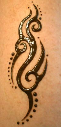 a tattoo design on the back of a woman's shoulder, with swirls and dots