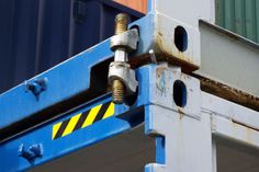 a close up of a blue and white pole with some containers in the back ground