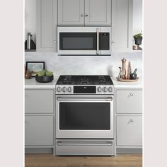 a stainless steel stove and microwave in a kitchen