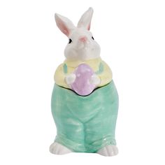 a white rabbit sitting on top of a green vase