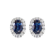 A halo of sparkling diamonds surrounds a faceted oval sapphire in this breathtaking pair of 14k white gold earrings. They are finished with a friction back post and measure approximately 6.5mm (1/4 inch) in width by 8mm (5/16 inch) in length. The 6 x 4mm genuine sapphires have a combined weight of 1.4 carats. The round diamonds vary in size, are I1 in clarity, G-H in color and have a total weight of 1/3 carat. The color range varies on all natural stones so please allow for slight variations in Diamond Cluster Earrings, Halo Earrings, Blue Sapphire Diamond, Bow Jewelry, Gemstone Stud Earrings, Gold Diamond Earrings, White Gold Earrings, Gemstone Studs, Emerald Jewelry