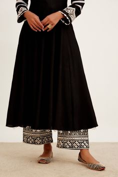 Black chanderi anarkali with embroidery detailing on the neckline and sleeves. Comes with an intricate embroidered palazzo and an embroidered organza dupatta.
Component: 3
Pattern: Embroidered
Type Of Work: Floral
Neckline: U-Neck
Sleeve Type: Three Quarter
Fabric: Chanderi, Shantoon and Organza
Color: Black
Other Details: 
Scalloped hem sleeves
Back tassel tie-up
Ringed tassel hem anarkali
Occasion: Sangeet - Aza Fashions Chanderi Anarkali, Blouse Measurement, Palazzo Set, Embroidery Detailing, Lehenga Blouse, Embroidered Organza, Organza Dupatta, Indian Designer Wear, U Neck