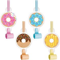 four doughnuts hanging from hooks on a white background