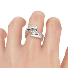 a woman's hand with two wedding rings on top of her finger and the other ring