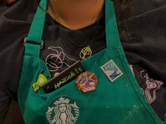 a woman wearing an apron with patches on it