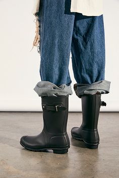 Get through rainy days with ease in these classic short rubber rain boots. In a matte rubber this style features a buckle accent on the side, logo detailing in front, and treaded rubber sole. * Pull-on style * Mid-calf height * Lifted heel | Hunter Short Wellies at Free People in Black, Size: US 9 Mid Calf Rain Boots Outfit, Styling Hunter Boots, Hunter Short Boots Outfit, Black Rainboots Outfit, Lighthouse Core, Rubber Boots Outfit, Hunter Rain Boots Outfit, Mid Calf Boots Outfit, Hunter Short Boots