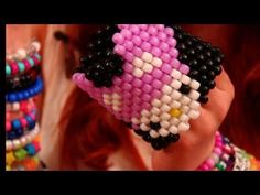 a close up of a person wearing bracelets with different colored beads on their wrist