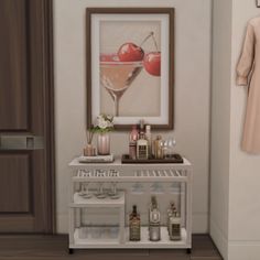 a white shelf with bottles and glasses on it in front of a framed photograph, next to an open door