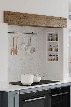 a kitchen with an oven, stove and counter top in the middle of it's wall