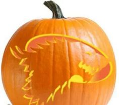 a carved pumpkin with an eagle on it's face in front of a white background