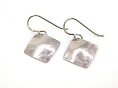 "The perfect daily go-to earrings! These handmade hammered square earrings are made with pure grade 1 titanium. The angled square earrings have a slight curve to them and they have been tumbled giving them a reflective shine.  For your nickel free ear wires, choose either niobium (for extra sensitive ears) or pure titanium from the drop-down menu. These earrings are nickel free and hypoallergenic, making them comfortable for anyone to wear. This style earring can be made in smaller or larger sizes or even anodized a color so contact me to request your desired size and/or color if desired. * Pure grade 1 titanium  * Niobium ear wire option (drop down menu) * Earring drop length 1\", angled square width 3/4\" * Lightweight * Nickel free  Pure titanium is considered the most hypoallergenic of Silver Square Hypoallergenic Earrings, Silver Hypoallergenic Square Earrings, Hypoallergenic Silver Square Earrings, Silver Hammered Rectangular Earrings, Extreme Metal, Titanium Jewelry, Titanium Earrings, Square Earrings, Sensitive Ears