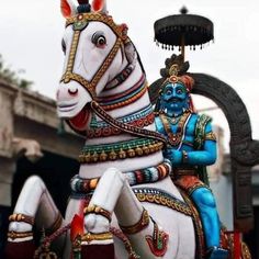 a statue of a man riding on top of a white horse