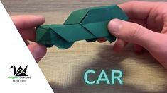 two hands holding origami pieces with the word car on it and an arrow