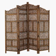 a wooden screen with intricate carvings on the sides and an openwork design at the top