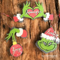 some ornaments are hanging from a tree trunk with the words,'christmas joy'written on them