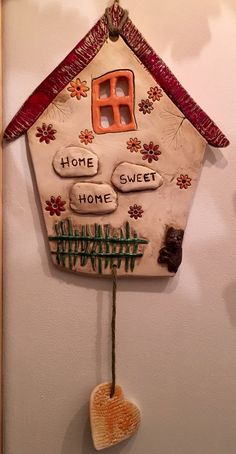 a house shaped decoration hanging on the wall