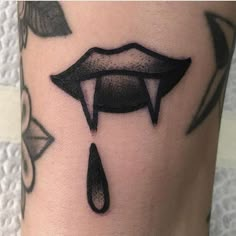 a woman's leg with black ink on it and an upside down lip tattoo