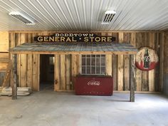 the inside of a building that is made out of wood and has a sign on it