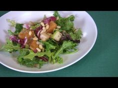 a white plate topped with lettuce and nuts