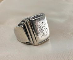 Massive 1920s antique silver German signet ring, with initials 'EL' or 'LE' engraved, the ring is in good antique condition.  Material: 800 silver Weight: 22.5 g US size: 9 (EU 60) Victorian Hallmarked Silver Signet Ring, Antique White Gold Signet Ring, Antique Engraved Signet Ring In Silver, Antique Engraved Silver Signet Ring, Antique Silver Signet Ring For Ceremonial Use, Antique Rectangular Engraved Signet Ring, Vintage Engraved Antique Silver Signet Ring, Antique Silver Stamped Signet Ring, Antique Silver Engraved Ring