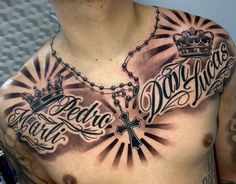 a man with tattoos on his chest has a cross and crown tattooed on the chest