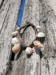 Crocheted Rustic Hemp Bracelet with Shell Crams Natural Beach Jewelry, No Metal, Hemp Rope Bracelet The base of this bracelet is a crocheted hemp rope (The most time-consuming part of this design.) The various small shell beads are also crocheted around the natural rope. the bracelet has a loop-knob closure. (I drilled the holes on every shell.) This one is for an average wrist, but feel free to request a different size. Beach Woven Friendship Bracelets, Handmade Brown Braided Bracelets For Beach, Beach Brown Macrame Braided Bracelet, Bohemian Adjustable Crochet Beaded Bracelets, Bohemian Adjustable Beaded Crochet Bracelets, Handmade Beige Bracelets For Vacation, Braided Friendship Bracelets For Beach, Beach Macrame Brown Friendship Bracelets, Woven Bracelet Jewelry For Beach