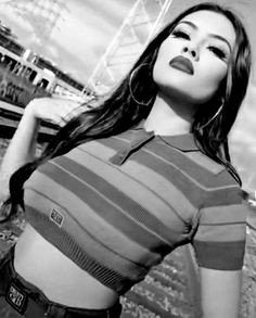 black and white photo of a woman with her hands on her hips wearing a striped shirt