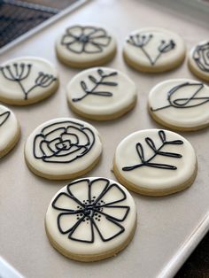 decorated cookies sitting on top of a cookie sheet