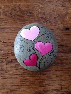 a rock with hearts painted on it