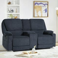 the reclining loveseat has two seats and a cup holder on top of it