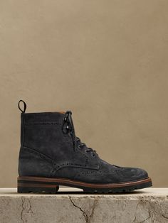 This handsome suede lace-up boot borrows its intricate detailing and wingtip toe from the classic brogue—a testament to its expert Portuguese craftsmanship.  Suede uppers.  Leather lining.  Rubber soles.  Made in Portugal.  Whole and half sizes. Dress Boots Men, Mens Suede Boots, Men's British Style, Mens Dress Boots, Brogue Boots, Rugged Style, Frye Boots, Suede Lace, British Style