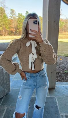 Stay cosy and stylish with this taupe cable-knit Bow Detail Sweater. Soft and breathable, this sweater features ivory double front ties and an open front with a slightly cropped design. Look effortlessly chic with this must-have piece. Model is 5'5" with a 35" bust, a 26" waist, and 37" hips wearing a size small- runs true to size! 58% acrylic, 27% polyester, 15% nylon Knit Bow, Detailed Sweater, Dresses By Length, Short Rompers, Top Sales, Bow Detail, Summer Collection, Set Dress, Cable Knit