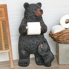 a statue of a bear holding a roll of toilet paper