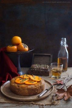 a cake on a plate with oranges next to it